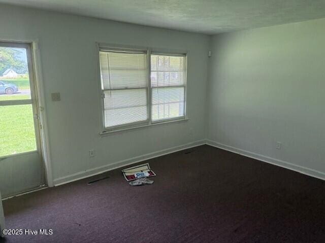 513 Hall Siding Rd, Ahoskie, NC 27910 - unfurnished room with dark carpet and baseboards