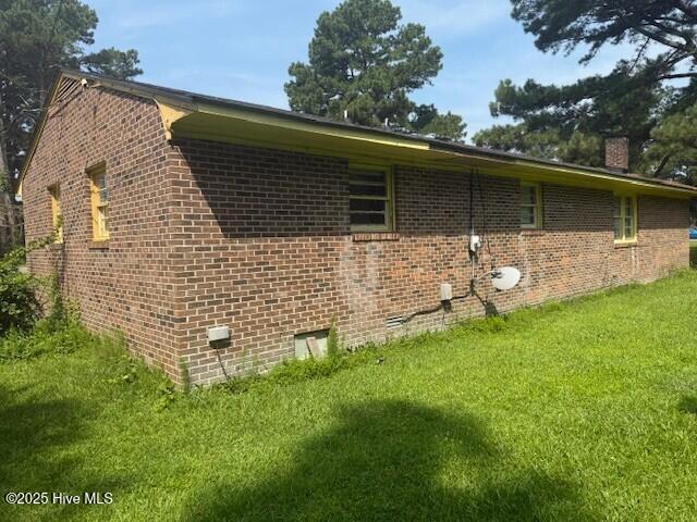 513 Hall Siding Rd, Ahoskie, NC 27910 - view of side of home featuring a lawn, brick siding, and a chimney