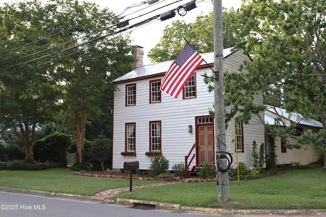 212 Carteret St, Bath, NC 27808 - colonial house with a chimney, a front lawn, a metal roof, and entry steps