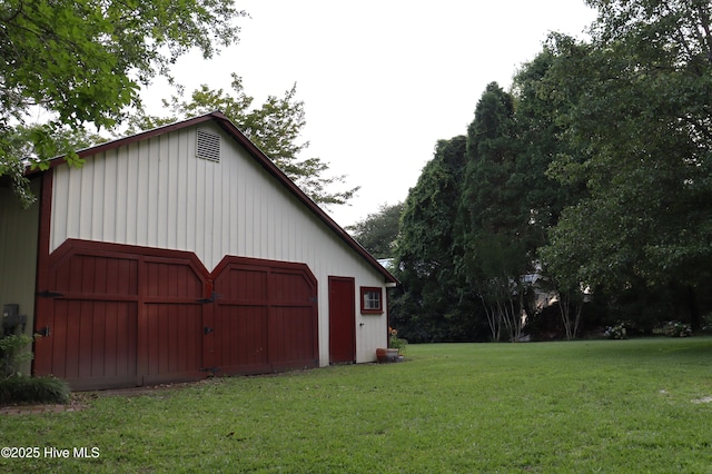 212 Carteret St, Bath, NC 27808 - view of side of home with a barn, an outdoor structure, a yard, and a garage
