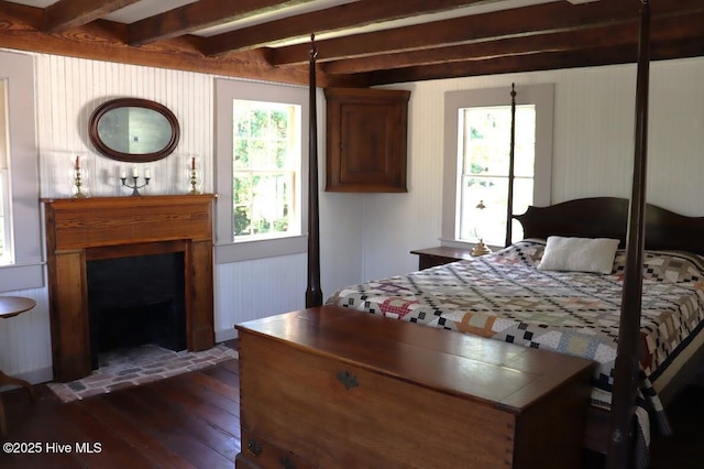 212 Carteret St, Bath, NC 27808 - bedroom featuring dark wood-type flooring, beamed ceiling, and a fireplace