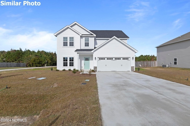 770 Aria Ln, Hubert, NC 28539 - traditional home featuring driveway, a shingled roof, board and batten siding, and an attached garage
