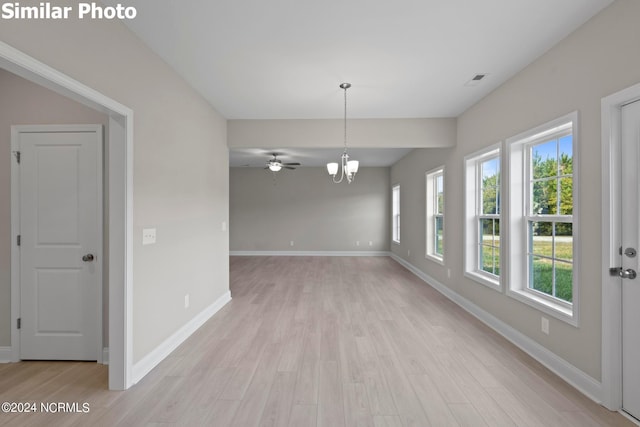 770 Aria Ln, Hubert, NC 28539 - empty room featuring light wood-type flooring, a chandelier, and a ceiling fan