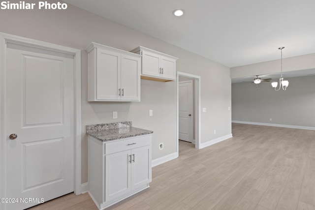 770 Aria Ln, Hubert, NC 28539 - kitchen with light stone counters, light wood finished floors, white cabinets, open floor plan, and recessed lighting