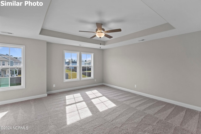 770 Aria Ln, Hubert, NC 28539 - empty room with a tray ceiling, carpet flooring, and ceiling fan