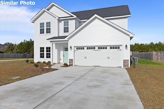 770 Aria Ln, Hubert, NC 28539 - traditional-style home featuring concrete driveway, stone siding, a garage, and board and batten siding