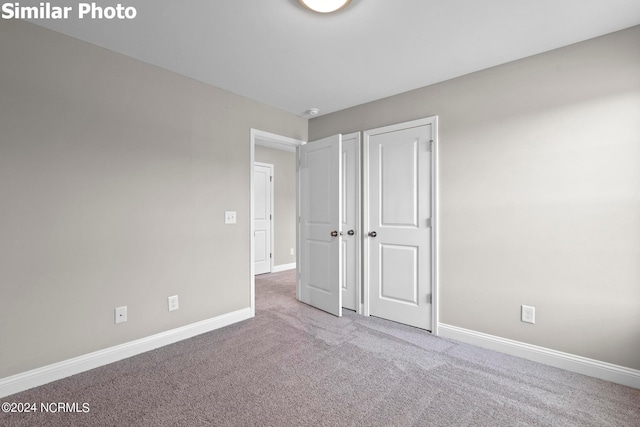 770 Aria Ln, Hubert, NC 28539 - unfurnished bedroom with baseboards and carpet flooring