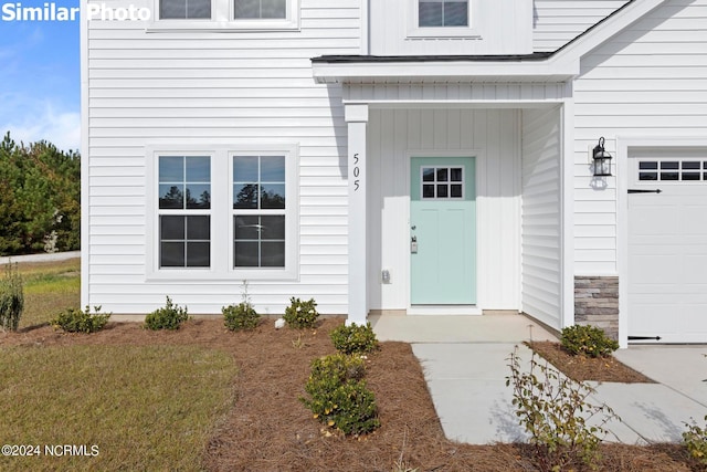 770 Aria Ln, Hubert, NC 28539 - view of exterior entry with a garage and stone siding