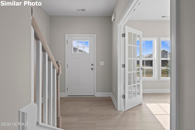 770 Aria Ln, Hubert, NC 28539 - foyer entrance with light wood finished floors and baseboards