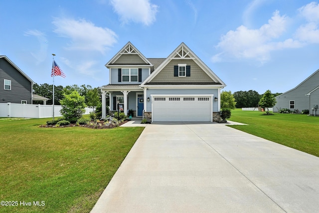 129 Glenmoor Path, Moyock, NC 27958 - craftsman-style house with driveway, stone siding, and covered porch