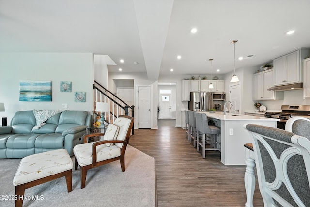 129 Glenmoor Path, Moyock, NC 27958 - living area with dark wood finished floors, recessed lighting, and stairway