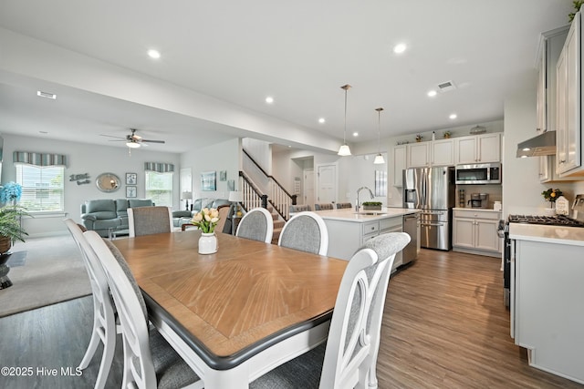 129 Glenmoor Path, Moyock, NC 27958 - dining space featuring a ceiling fan, dark wood-style flooring, recessed lighting, and stairs
