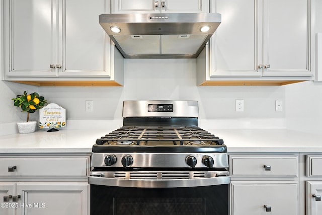 129 Glenmoor Path, Moyock, NC 27958 - kitchen featuring stainless steel range with gas cooktop, under cabinet range hood, light countertops, and white cabinetry
