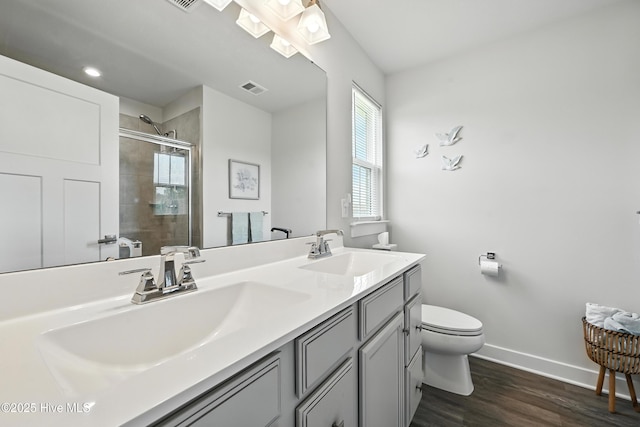 129 Glenmoor Path, Moyock, NC 27958 - full bath featuring double vanity, a stall shower, and wood finished floors