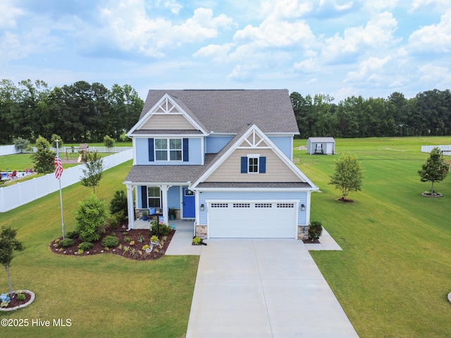 129 Glenmoor Path, Moyock, NC 27958 - craftsman-style house with driveway, a porch, an attached garage, roof with shingles, and stone siding