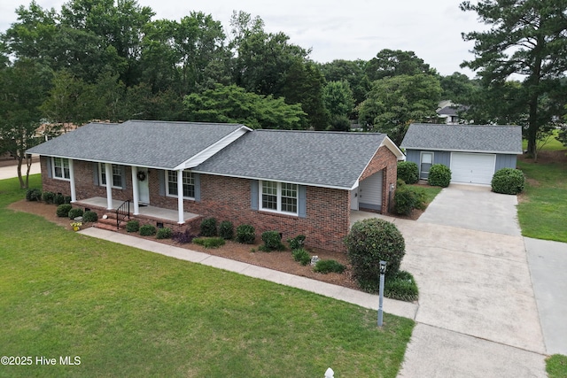 2704 Forrest Dr, Kinston, NC 28504 - ranch-style home featuring driveway, a shingled roof, covered porch, brick siding, and a front yard