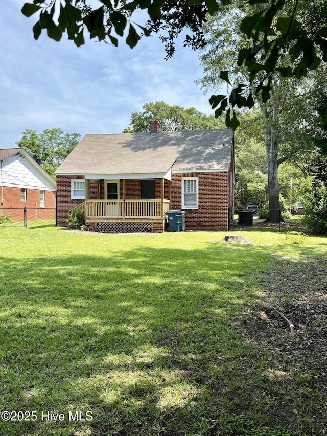 603 E 8th St, Washington, NC 27889 - view of front of house with brick siding, a chimney, and a wooden deck