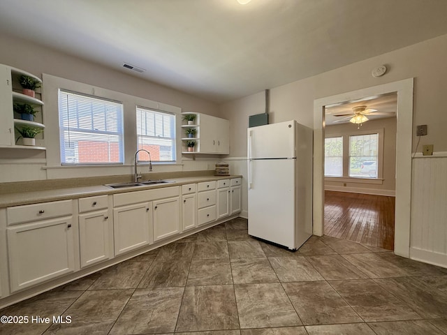 603 E 8th St, Washington, NC 27889 - kitchen featuring freestanding refrigerator, open shelves, white cabinetry, ceiling fan, and light countertops