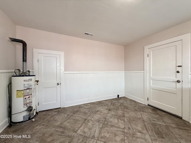603 E 8th St, Washington, NC 27889 - empty room with water heater and wainscoting