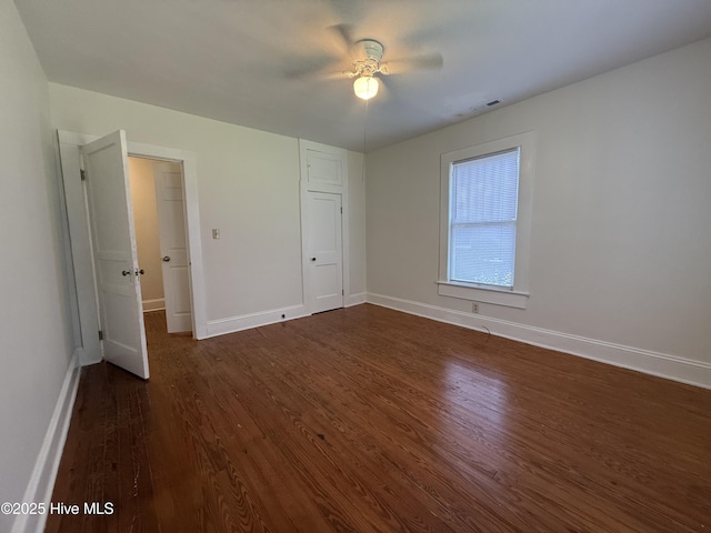 603 E 8th St, Washington, NC 27889 - unfurnished bedroom featuring dark wood-style floors and ceiling fan