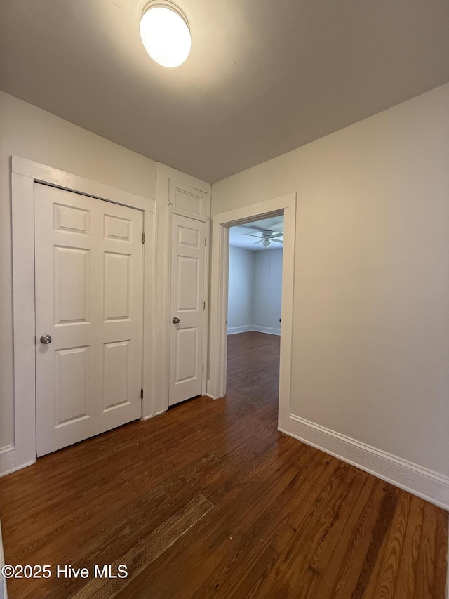 603 E 8th St, Washington, NC 27889 - spare room featuring baseboards and dark wood-style floors