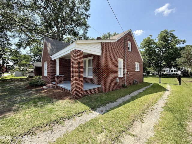 603 E 8th St, Washington, NC 27889 - view of home's exterior with a yard and brick siding