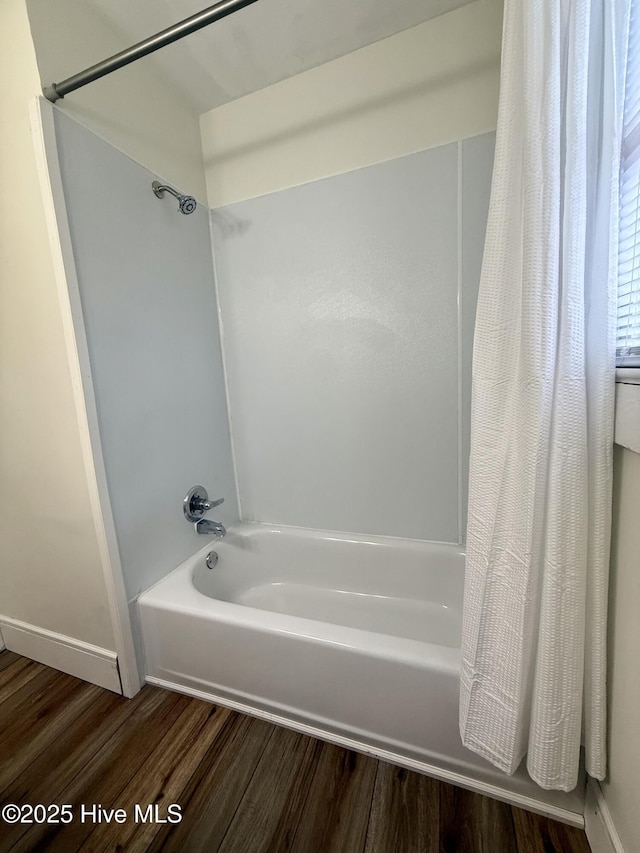 603 E 8th St, Washington, NC 27889 - bathroom featuring wood finished floors and shower / bath combo with shower curtain