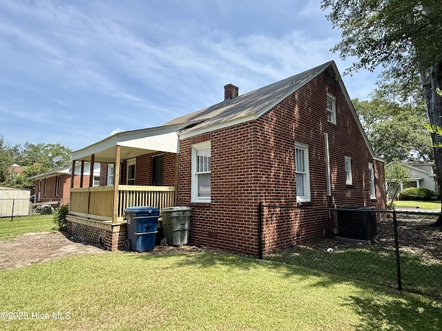 603 E 8th St, Washington, NC 27889 - view of property exterior featuring brick siding, a porch, and a chimney