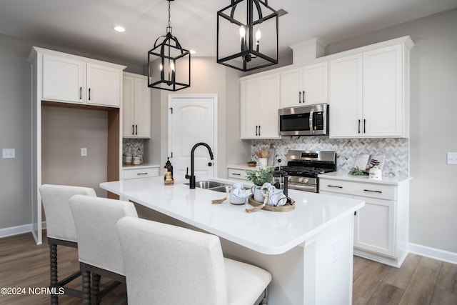 301 Glassmine Trl Unit 48, Aberdeen, NC 28315 - kitchen with appliances with stainless steel finishes, an island with sink, white cabinets, backsplash, and recessed lighting