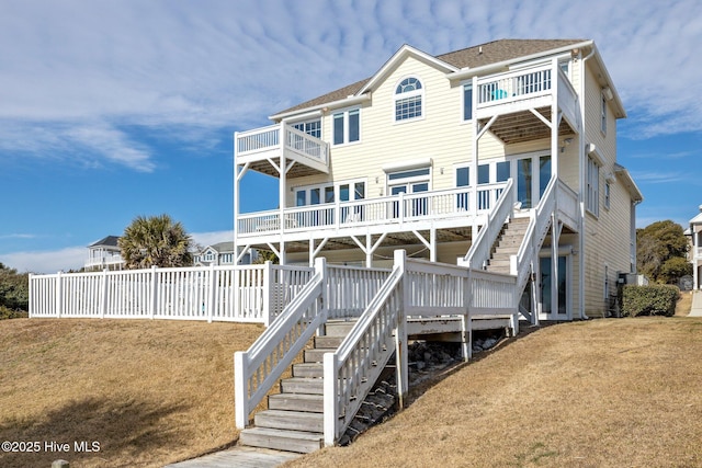 9711 Dolphin Ridge Rd, Emerald Isle, NC 28594 - rear view of house with a balcony, stairway, roof with shingles, and a deck