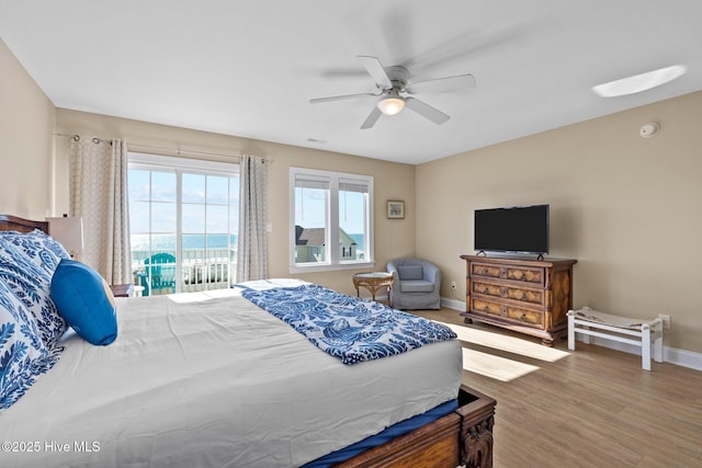 9711 Dolphin Ridge Rd, Emerald Isle, NC 28594 - bedroom featuring multiple windows, access to outside, wood finished floors, and a ceiling fan
