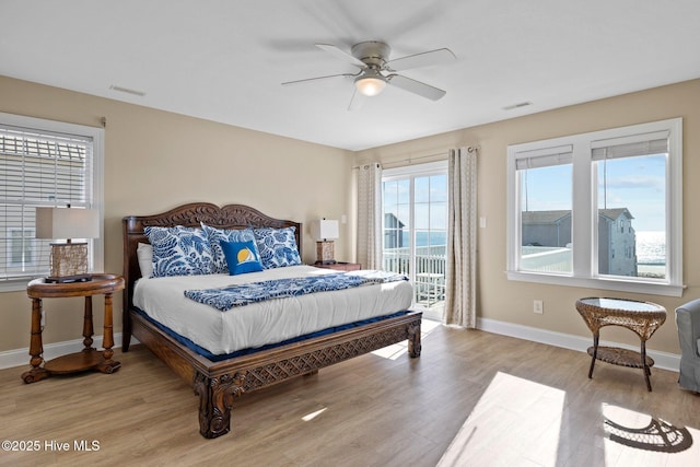 9711 Dolphin Ridge Rd, Emerald Isle, NC 28594 - bedroom featuring access to exterior, light wood-style flooring, and ceiling fan