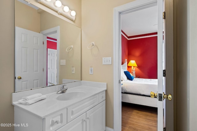 9711 Dolphin Ridge Rd, Emerald Isle, NC 28594 - bathroom featuring vanity, connected bathroom, and wood finished floors