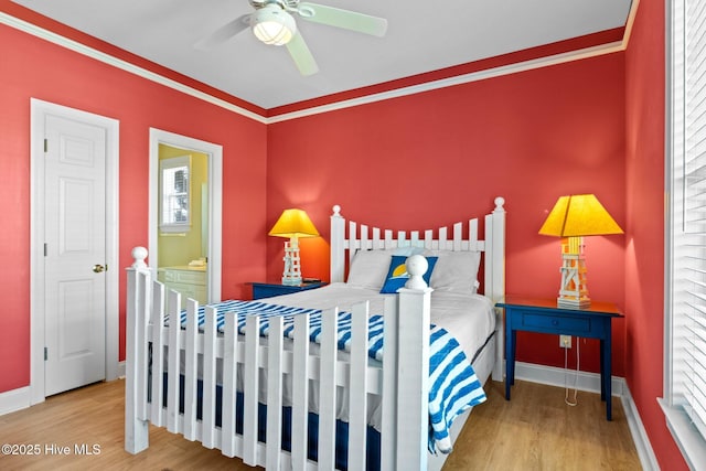 9711 Dolphin Ridge Rd, Emerald Isle, NC 28594 - bedroom with wood finished floors, ornamental molding, ensuite bath, and a ceiling fan