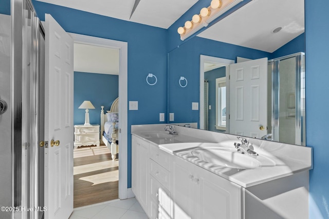 9711 Dolphin Ridge Rd, Emerald Isle, NC 28594 - full bath featuring connected bathroom, double vanity, tile patterned floors, and a shower with shower door