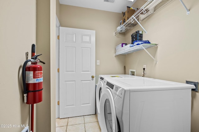 9711 Dolphin Ridge Rd, Emerald Isle, NC 28594 - laundry room with washing machine and clothes dryer and light tile patterned floors