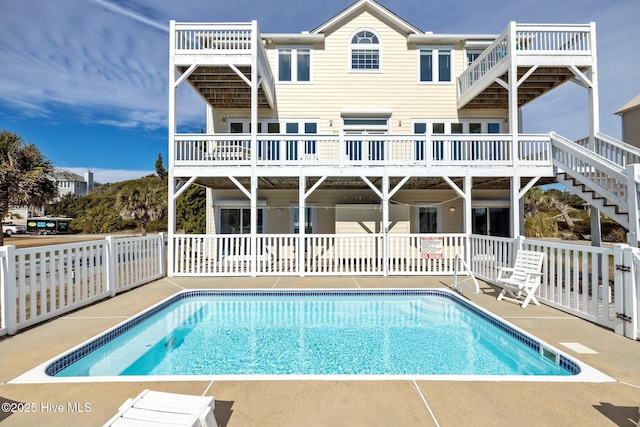 9711 Dolphin Ridge Rd, Emerald Isle, NC 28594 - back of house featuring a patio area and stairway