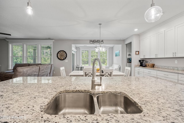 145 Beechnut Ave, South Mills, NC 27976 - kitchen featuring pendant lighting, light stone countertops, white cabinetry, and healthy amount of natural light