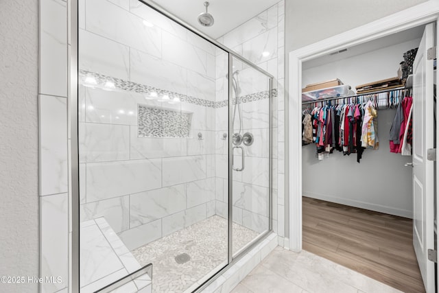 145 Beechnut Ave, South Mills, NC 27976 - full bathroom featuring a shower stall, a spacious closet, and wood finished floors
