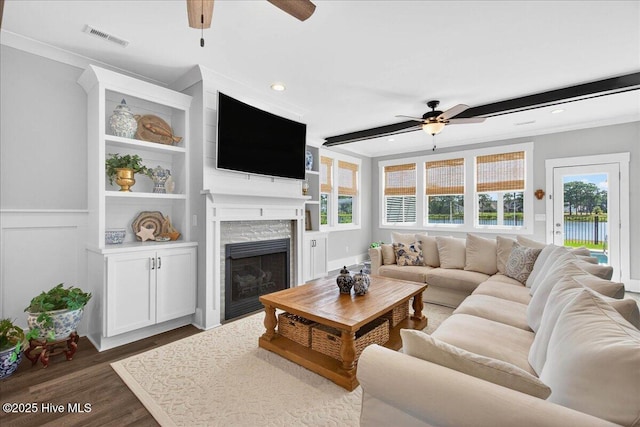 385 Summerhouse Dr, Holly Ridge, NC 28445 - living room with ceiling fan, wood finished floors, a stone fireplace, recessed lighting, and ornamental molding