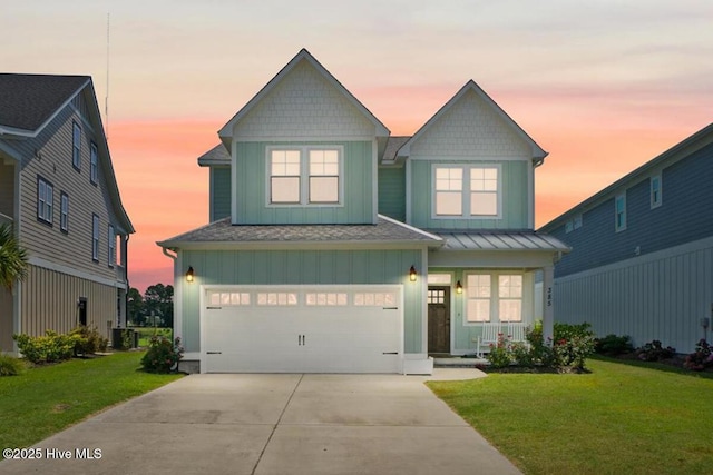 385 Summerhouse Dr, Holly Ridge, NC 28445 - view of front of property with a lawn, concrete driveway, a garage, and board and batten siding