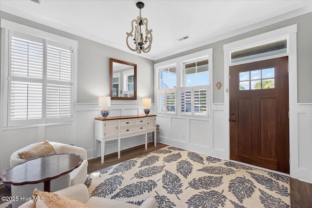 385 Summerhouse Dr, Holly Ridge, NC 28445 - entryway with wainscoting, a chandelier, wood finished floors, and a decorative wall