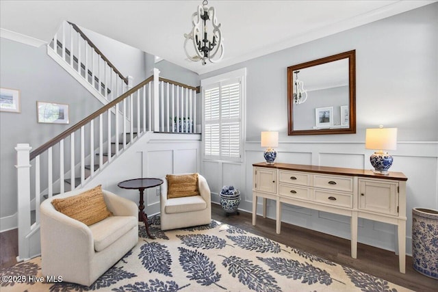 385 Summerhouse Dr, Holly Ridge, NC 28445 - sitting room with wood finished floors, stairs, a chandelier, wainscoting, and a decorative wall