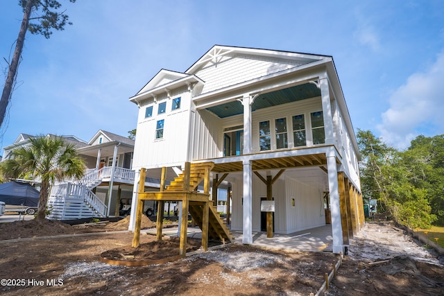 337 NE 48th St, Oak Island, NC 28465 - view of front of house with a carport, stairs, a porch, and board and batten siding