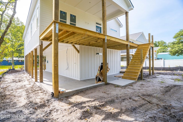 337 NE 48th St, Oak Island, NC 28465 - rear view of property featuring stairway and board and batten siding