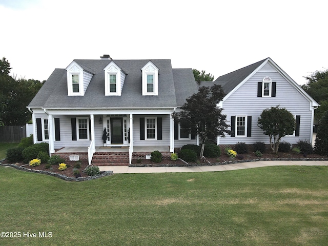 4409 Pinehurst Dr N, Wilson, NC 27896 - cape cod home with covered porch, a front lawn, a chimney, and roof with shingles
