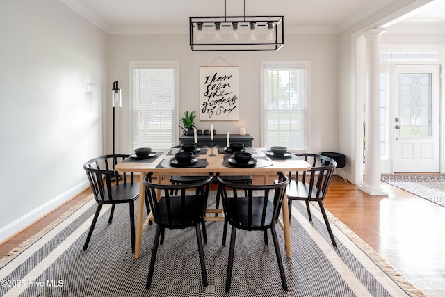 4409 Pinehurst Dr N, Wilson, NC 27896 - dining room featuring ornate columns, light wood finished floors, and ornamental molding