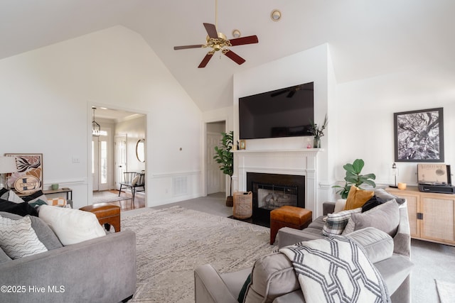 4409 Pinehurst Dr N, Wilson, NC 27896 - carpeted living room with high vaulted ceiling, ceiling fan, a fireplace with flush hearth, and wainscoting