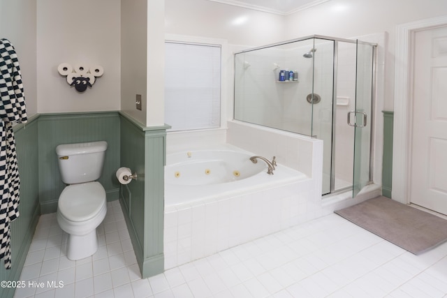 4409 Pinehurst Dr N, Wilson, NC 27896 - full bathroom featuring a whirlpool tub, a stall shower, tile patterned flooring, and wainscoting