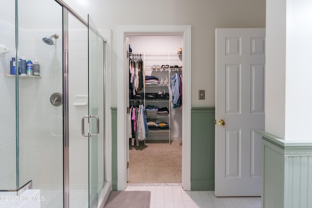 4409 Pinehurst Dr N, Wilson, NC 27896 - bathroom featuring a stall shower, a walk in closet, and tile patterned flooring